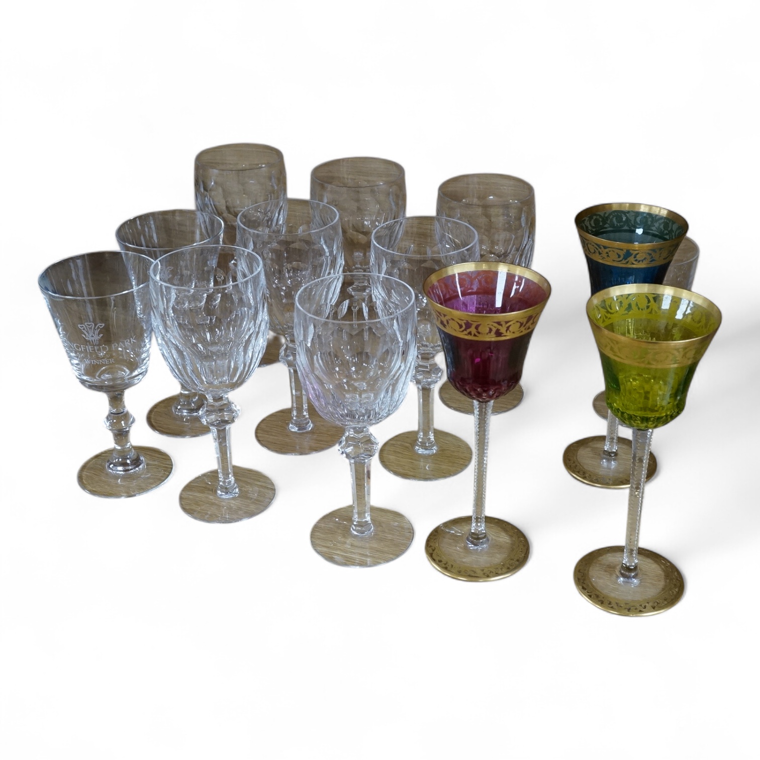 Three coloured wine glasses, a set of seven cut wine glasses, a commemorative Churchill glass and two horse-racing related glasses. Tallest 21cm., Condition - fair